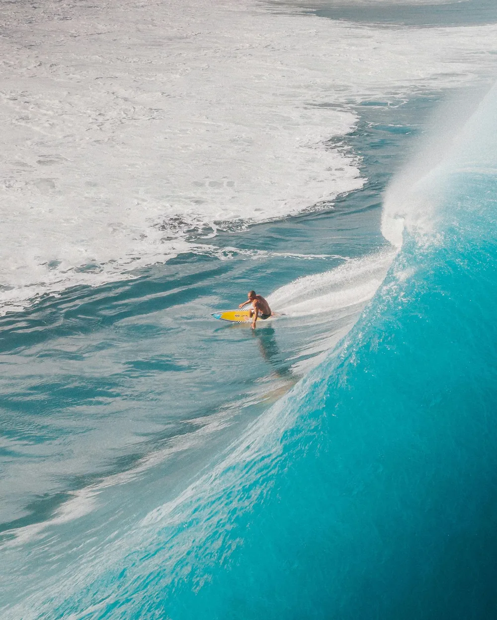 A surfer setting a bottom turn